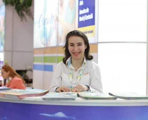 Contacts Cocktail Holidays woman at tourism fair